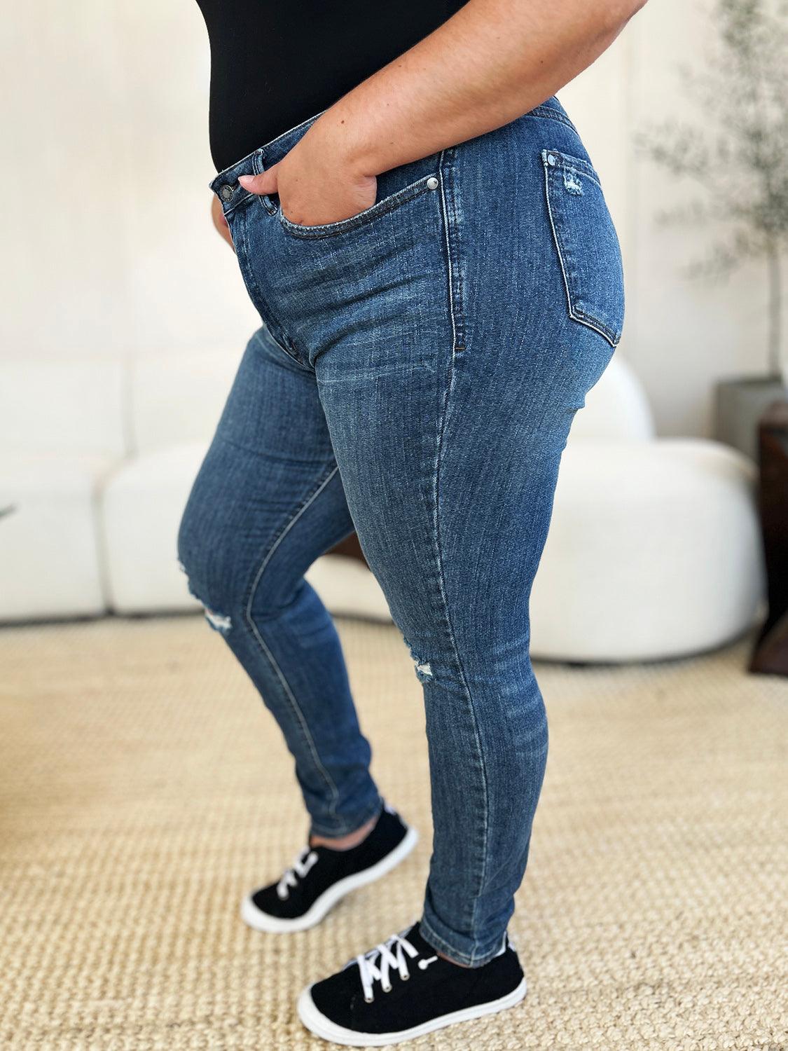 Get trendy with Full Size Mid Waist Distressed Slim Jeans - Plus Size available at Styles Code. Grab yours today!