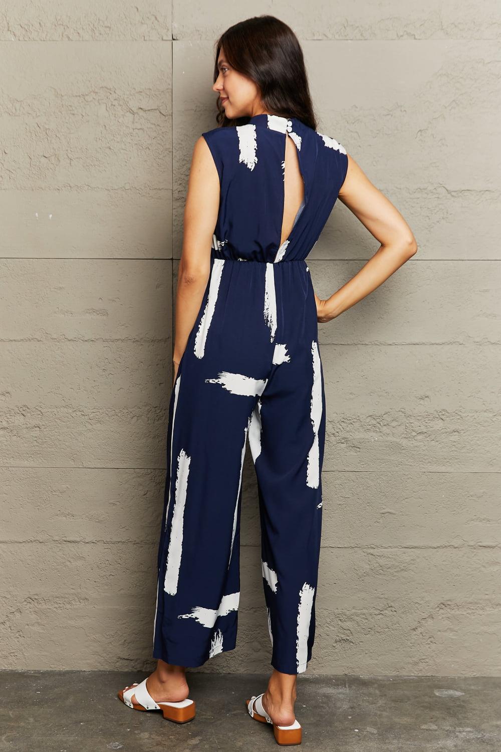 Get trendy with Printed Round Neck Cutout Jumpsuit with Pockets - Jumpsuits available at Styles Code. Grab yours today!