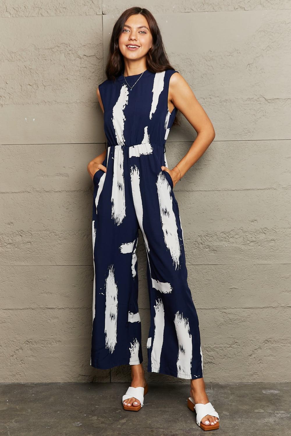 Get trendy with Printed Round Neck Cutout Jumpsuit with Pockets - Jumpsuits available at Styles Code. Grab yours today!