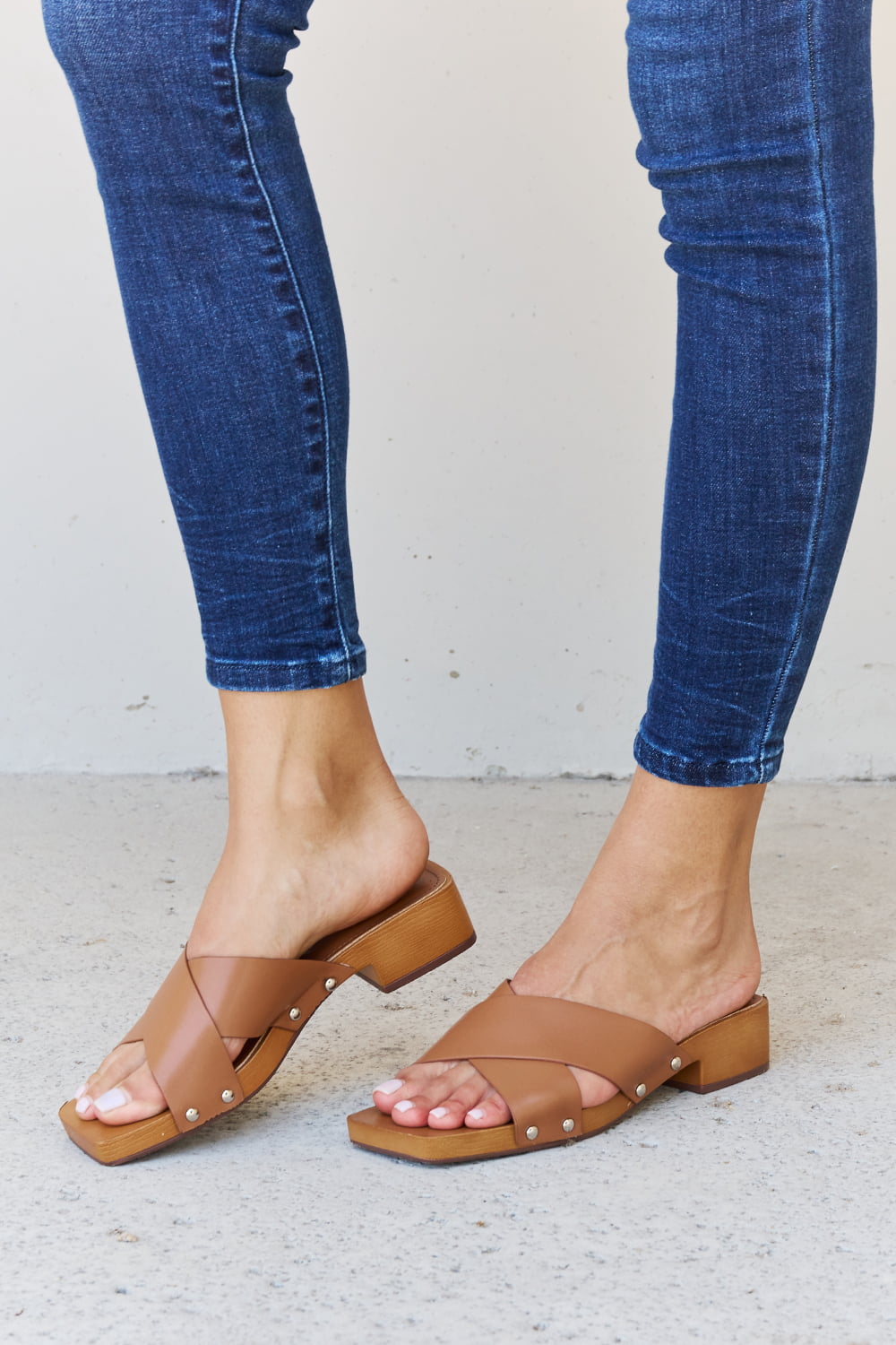 Get trendy with Weeboo Step Into Summer Criss Cross Wooden Clog Mule in Brown - Shoes available at Styles Code. Grab yours today!