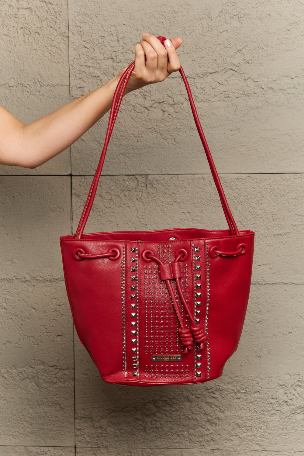 Get trendy with Nicole Lee USA Amy Studded Bucket Bag - Bags available at Styles Code. Grab yours today!