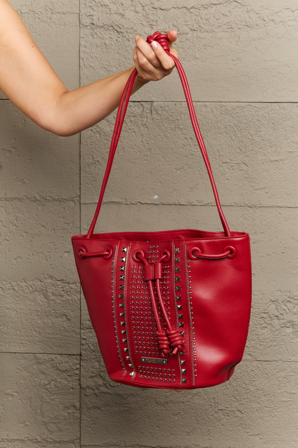 Get trendy with Nicole Lee USA Amy Studded Bucket Bag - Bags available at Styles Code. Grab yours today!