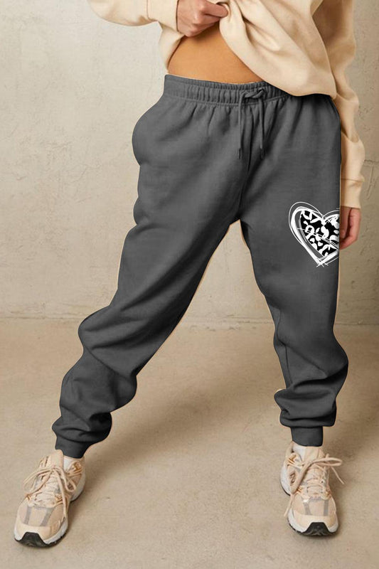 Get trendy with Simply Love Simply Love Full Size Drawstring Heart Graphic Long Sweatpants - Graphic Sweatpants available at Styles Code. Grab yours today!