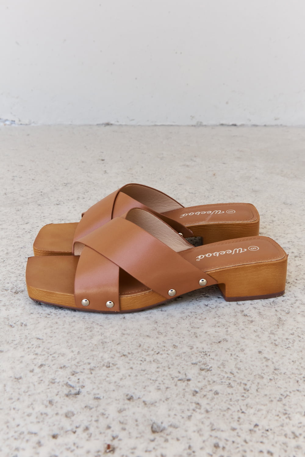 Get trendy with Weeboo Step Into Summer Criss Cross Wooden Clog Mule in Brown - Shoes available at Styles Code. Grab yours today!