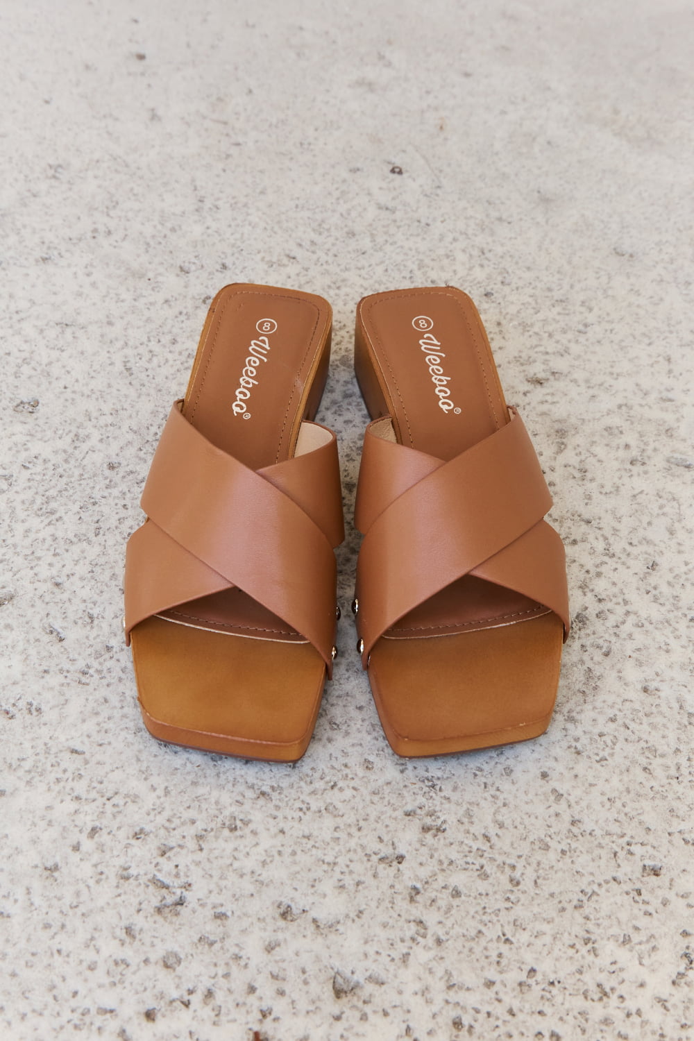 Get trendy with Weeboo Step Into Summer Criss Cross Wooden Clog Mule in Brown - Shoes available at Styles Code. Grab yours today!